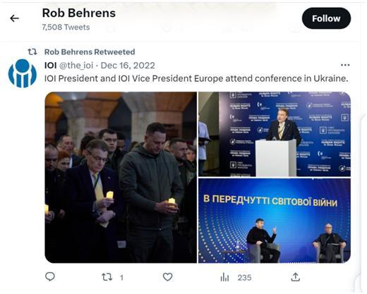 Field holding a candle at the Human Rights in Dark Hours conference, tweeted by Behrens