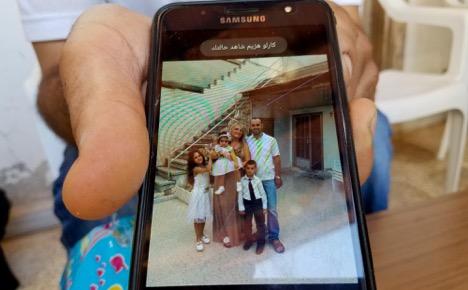 Shadi Yousef Shehda shows a photo of his wife, three young children and mother, all killed in a missile attack on their Mhardeh home. Sep 7, 2018. (Photo: Eva Bartlett)